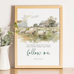 May include: A framed watercolour print depicting sheep in a field with a barn in the background. The print includes the text "MY SHEEP HEAR MY VOICE, AND I KNOW THEM, AND THEY follow me. John 10:27" in green script.