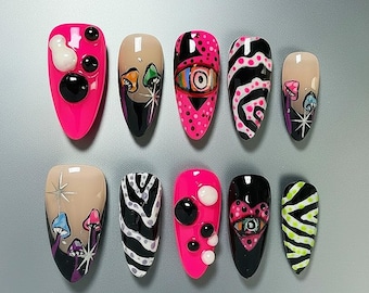 Uñas postizas Y2K 3D rosa y negro con diseño abstracto de ojo de cebra y forma almendrada.