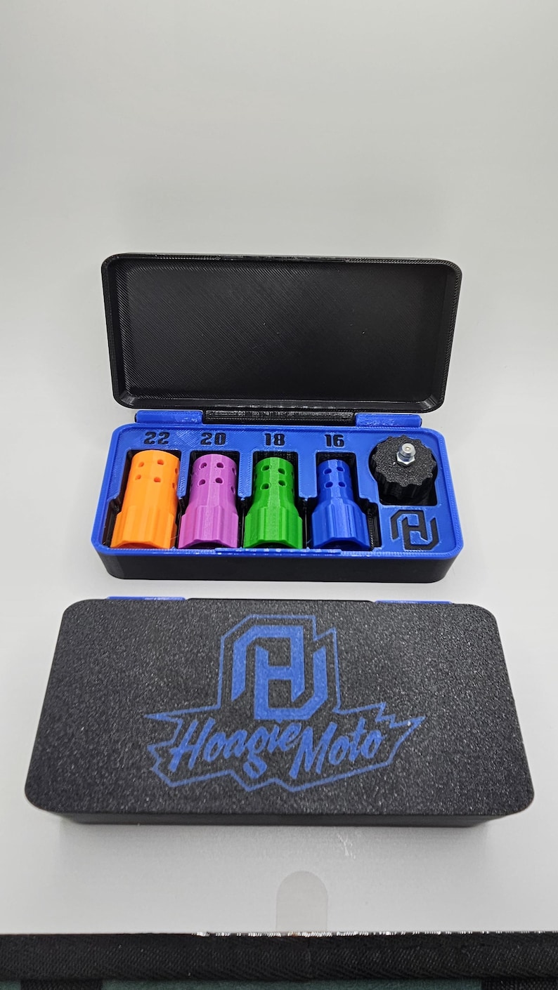 May include: A black case with a blue interior holds various colored tools. The tools are orange, purple, green, and blue, with numbers 22, 20, 18, and 16 above them. The case also contains a black component. The bottom case has the text "Hoagie Moto".