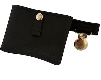 May include: Black faux leather fanny pack with a gold-colored metal clasp and button closure. The small pouch has a textured surface and a black elastic strap.