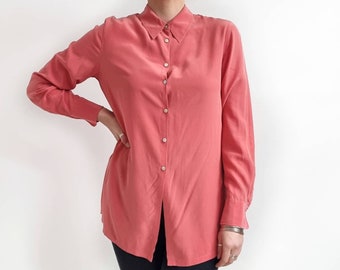 May include: A long-sleeved, coral pink button-down shirt with a relaxed fit.