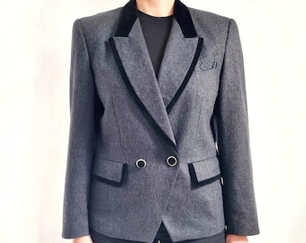 May include: A grey blazer with a black velvet collar and trim. The blazer has a double-breasted closure with gold buttons.