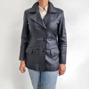 May include: A black leather jacket with a double-breasted closure and two front pockets.