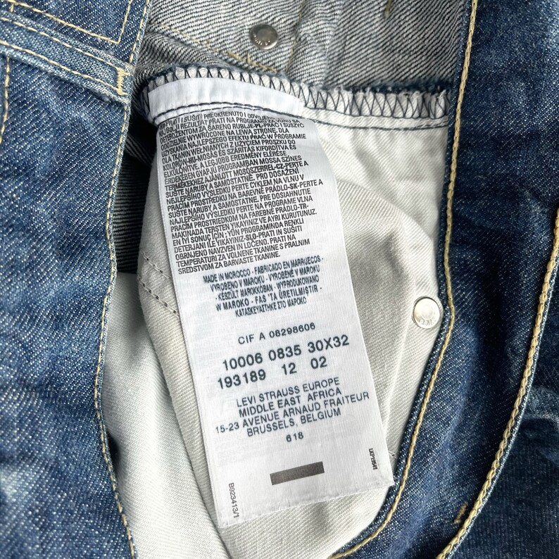 May include: A white Levi's clothing care label with black text. The label includes the Levi's logo, size information, and the text "Made in Morocco".