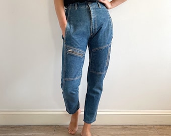 May include: A pair of blue denim jeans with cargo pockets and zipper details.