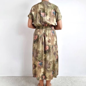 May include: A long, green floral print dress with a gathered waist and short sleeves.