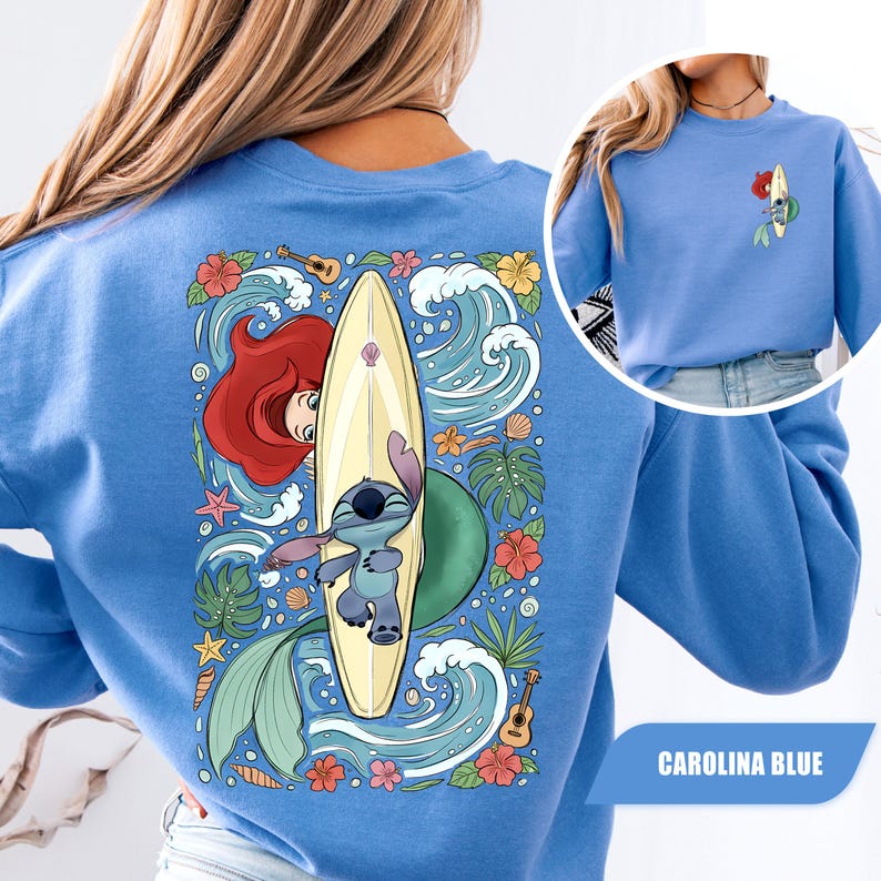 May include: A Carolina blue sweatshirt featuring a large back graphic of Ariel and Stitch with a surfboard, surrounded by tropical flowers, waves, and ukuleles. A smaller version of the same graphic is printed on the front left chest area.