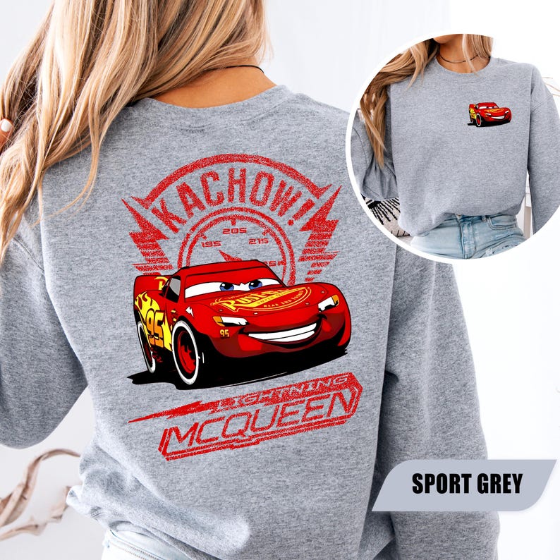 May include: A sport grey sweatshirt featuring a large graphic on the back of the red race car Lightning McQueen with the text KACHOW! and LIGHTNING MCQUEEN. A smaller version of the same red race car graphic is printed on the front left chest area.