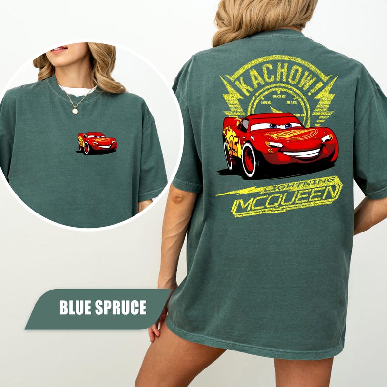 May include: A blue spruce t-shirt featuring a small graphic of Lightning McQueen on the front left chest and a large graphic on the back with the text KACHOW! and LIGHTNING MCQUEEN surrounding the red race car character with the number 95.