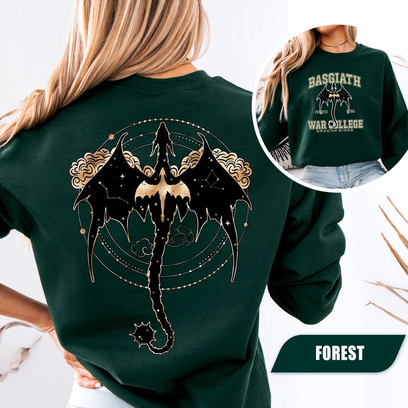 May include: Forest green sweatshirt featuring a black and gold dragon design on the back. The dragon is surrounded by a constellation pattern. A smaller image shows the text "BASGIATH WAR COLLEGE DRAGON RIDER".