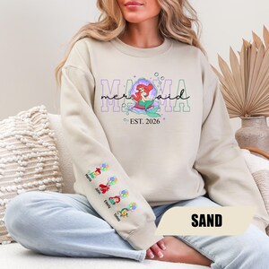 May include: A set of three ceramic mugs with a speckled, matte finish. The mugs are in shades of cream, light gray, and dark gray. Each mug has a simple, minimalist design and a rounded handle.