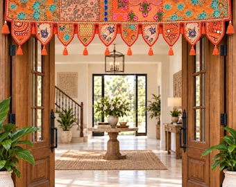 May include: A vibrant orange fabric door valance featuring intricate multi-colored floral embroidery, sequin embellishments, and small circular mirrors. The valance has a scalloped bottom edge finished with decorative tassels and hanging beads.