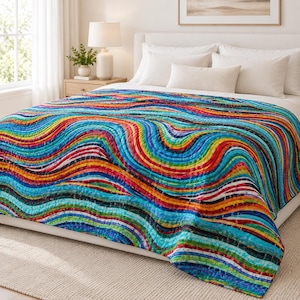 May include: A quilt featuring a vibrant, multi-colored pattern of undulating, horizontal wavy lines in shades of blue, red, yellow, green, and purple. The fabric has a quilted texture with visible stitching lines following the wave pattern.