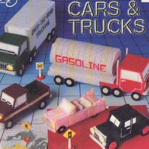 May include: A colorful plastic canvas pattern book titled "Cars & Trucks" featuring various handmade car and truck models. The cover includes the text "7 fun projects by Karen McDanel". The models include a red truck, a black car, and a yellow convertible.