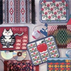 May include: A book cover featuring various plastic canvas mousepad designs. The designs include floral patterns, geometric shapes, and a cat with the text "Mice Rule." The cover also displays the text "MOUSEPADS" and "16 designs in 7-mesh canvas."