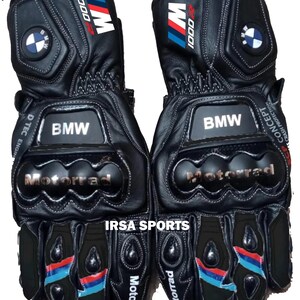 May include: Pair of black leather motorcycle gloves with BMW and Motorrad branding. Features include blue, red, and white accents, along with the text "1000" and "IRSA SPORTS".
