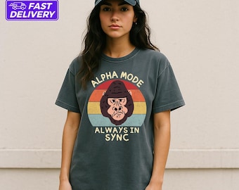 May include: A dark gray t-shirt with a vintage-style graphic of a gorilla with the text "Alpha Mode Always In Sync".