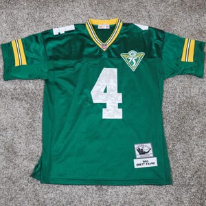 Puede incluir: Camiseta de fútbol verde con el número 4 blanco en la parte delantera. La camiseta tiene detalles amarillos y blancos en las mangas y el cuello. Un parche con el número 75 está en el pecho. Camiseta retro Mitchell & Ness, 1993 Brett Favre.