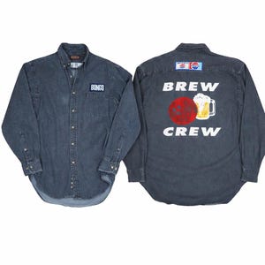 May include: Dark denim button-down shirt with "BONGO" text on the front pocket. The back features a "BREW CREW" design with a red circle and a beer mug graphic. A Pepsi patch is visible.