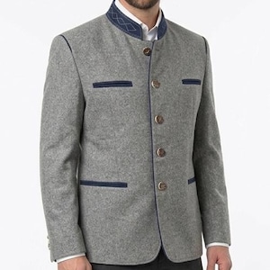 May include: A gray wool jacket with a mandarin collar and navy blue trim. The jacket features decorative buttons and pocket details. The jacket is a classic style.