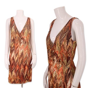 May include: A sleeveless wrap dress with a V-neckline and a brown, orange and white abstract print.
