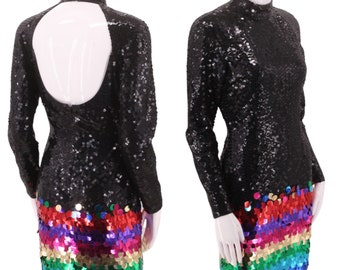 May include: A black sequined mini dress with long sleeves and a keyhole back. The bottom of the dress features a rainbow of sequins.