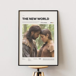 May include: Framed movie poster for "The New World" with a black frame. The poster features a couple with their foreheads touching, set against a forest backdrop. The title is at the top.