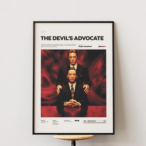 May include: A movie poster for the film "The Devil's Advocate" starring Keanu Reeves and Al Pacino. The poster features a red background with the two actors in suits. The text "The Devil's Advocate" is in large white letters at the top of the poster.