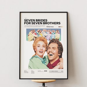 Può includere: Poster cinematografico incorniciato per "Seven Brides for Seven Brothers" con un'immagine colorata del cast. Il poster ha una cornice nera ed è esposto su una parete bianca. Il poster include il titolo del film e il nome del regista.