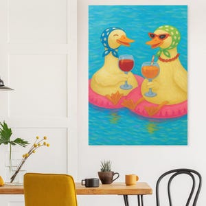 May include: A whimsical painting depicts two yellow ducks in a pool, each wearing a headscarf and sunglasses, and holding a glass of wine. They are floating on a pink inflatable ring. The water is blue.