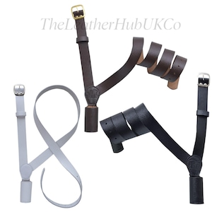May include: Three leather sword slings in different colours: brown, black, and white. Each sling has a brass buckle and a leather loop for attaching to a sword.