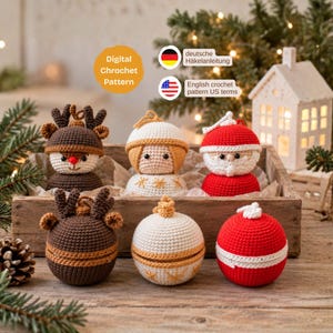 May include: Six crocheted ornaments in a wooden crate, including a reindeer, a person with blonde hair, and a Santa Claus figure, along with three matching spherical ornaments in brown, white, and red. Text reads Digital Crochet Pattern.