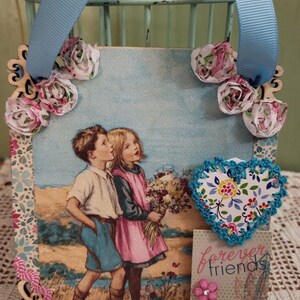 Boy and Girl Strolling on the Beach with Flowers Hanging Decoration