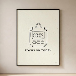 May include: Black framed print featuring a stopwatch illustration with the time 00:05 displayed. Below the stopwatch is the text "FOCUS ON TODAY". The artwork is in black and white, set against a cream-colored background.