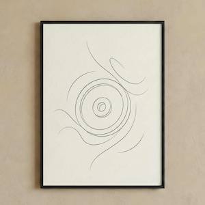 May include: Black framed art print with a minimalist line drawing. The artwork features concentric circles at the centre, encircled by flowing, curved lines. The background is a light cream colour, and the frame is black.