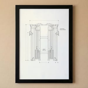 May include: Black framed print of a weight machine blueprint. The print features detailed line drawings of the machine, including measurements and labels such as "Adjustable Pulley System" and "Weight Stack (250)". The artwork is displayed on a white background.