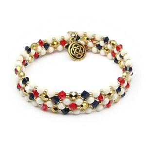 May include: A triple-strand beaded bracelet with white, red, and blue beads, accented with gold beads and a gold Celtic knot charm.