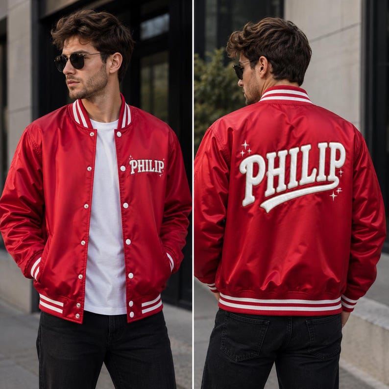 May include: A red varsity jacket with white striped ribbed trim on the collar, cuffs, and hem. The front features the name PHILIP in white embroidery. The back displays the name PHILIP in large white lettering with small star accents.