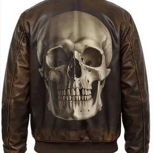 May include: Brown leather bomber jacket with a large skull design on the back. The jacket has a ribbed collar, cuffs, and hem. The skull is detailed with shading and highlights, giving it a realistic look. The jacket is a medium brown colour.