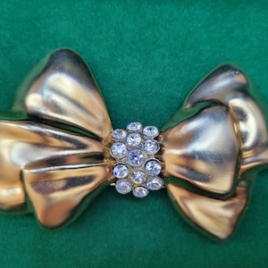 Statement Gold Bow Brooch with Rhinestone Center