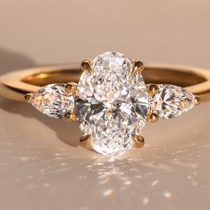 Lab Grown Oval Diamond Engagement Ring: Gold Three Stone Pear Accents