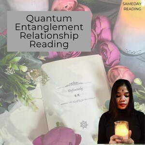 May include: A book with the text "Definitely" and a floral design on the cover. A woman is holding a lit candle in front of the book. The text "Quantum Entanglement Relationship Reading" is on a gray background.