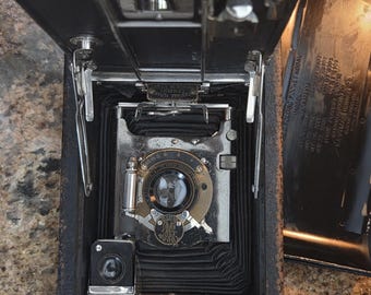 Vintage item is a Kodak No. 3A Folding Pocket Camera, a popular collectible produced in the early 20th