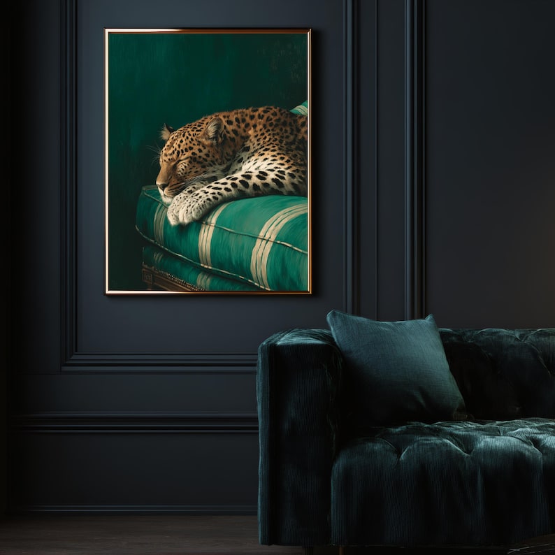 May include: A framed art print featuring a sleeping leopard. The leopard rests on a green and white striped cushion. The artwork is set against a dark green background and framed in gold.