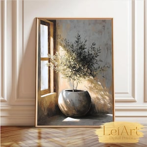 Puede incluir: Impresión artística enmarcada de un olivo en maceta en una habitación soleada. El árbol está en una maceta grande, redonda y gris. La obra de arte tiene una paleta de colores neutros con tonos cálidos.