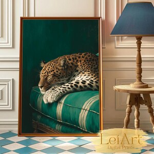May include: A framed print featuring a sleeping leopard with spotted fur, resting on a green striped cushion. The artwork has a gold frame and is set against a dark green background. The print is labeled "LeiArt Digital Prints".
