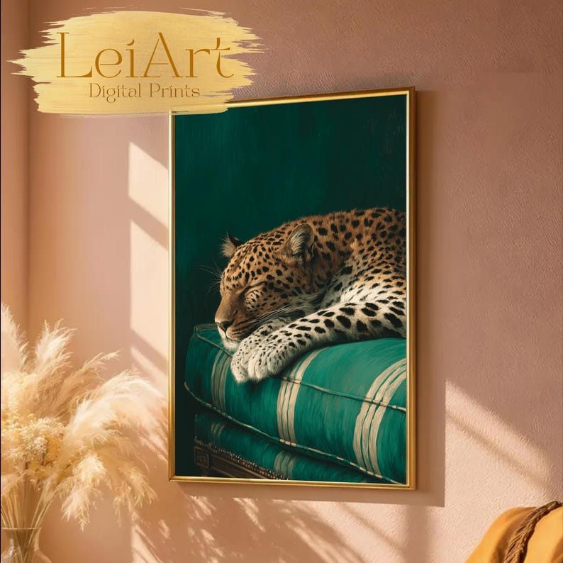 May include: A framed art print featuring a sleeping leopard on a green striped cushion. The leopard has a spotted coat and is resting its head. The artwork is framed in a gold-colored frame. The text "LeiArt Digital Prints" is in the upper left corner.
