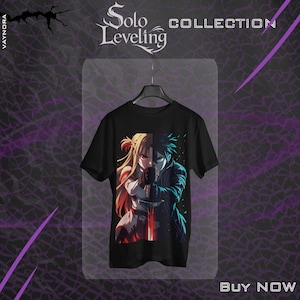 May include: Black t-shirt featuring a split design of two anime characters, one with blonde hair and the other with blue hair, holding a sword. The shirt has the text "Solo Leveling Collection" at the top and "Buy Now" at the bottom.