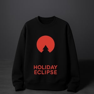 May include: Black sweatshirt with a red graphic of a tree inside a circle, with the words "HOLIDAY ECLIPSE" in red below the graphic. The sweatshirt is displayed on a dark gray background.