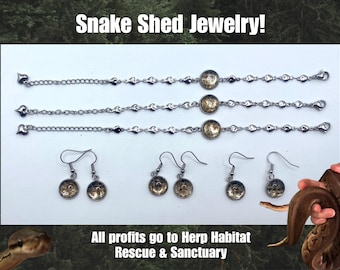 May include: Snake Shed Jewelry! The image displays three silver bracelets and three pairs of earrings. Each piece features a circular charm with a unique design. The text "Snake Shed Jewelry!" and "All profits go to Herp Habitat Rescue & Sanctuary" are also visible.